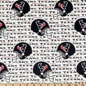 May include: A white fabric featuring a repeating pattern of dark blue Houston Texans football helmets with red and white logos, interspersed with the repeated black text "HOUSTON TEXANS" printed in a bold, sans-serif font across the entire surface.
