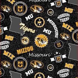 May include: A black fabric with a repeating pattern featuring the Missouri Tigers logo, the text Mizzou, Missouri, and Tigers, the state of Missouri in gray, and yellow and black tiger head icons, all set against a textured dark background.