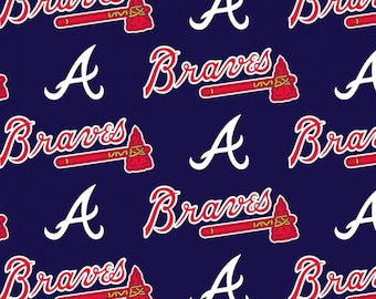 May include: A dark navy blue fabric featuring a repeating pattern of the Atlanta Braves logo. The design includes the word Braves in white script with a red outline, accompanied by a red tomahawk icon, and a separate white capital letter A.