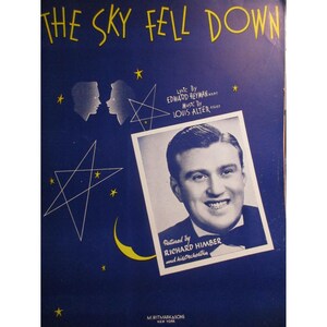 Puede incluir: Una portada de partitura vintage para la canción "The Sky Fell Down" de Edward Heyman y Louis Alter. La portada presenta un fondo azul con estrellas amarillas y una luna creciente, y una foto en blanco y negro de Richard Himber y su orquesta.