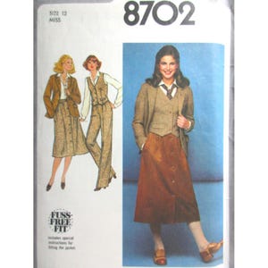 May include: Vintage sewing pattern for a woman's suit, including a skirt, jacket, and waistcoat. The pattern is for a Misses' size 12. The image shows a woman in a brown button-down skirt, a brown jacket, and a waistcoat.