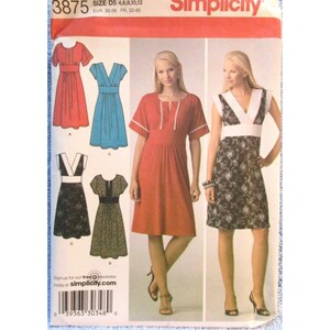 Może przedstawiać: Wzór szycia Simplicity 3875 z różnymi wzorami sukienek. Wzór zawiera rozmiary D5 (4, 6, 8, 10, 12) oraz rozmiary europejskie 30-38. Obraz przedstawia czerwoną sukienkę, niebieską sukienkę oraz sukienki z kwiatowymi wzorami.