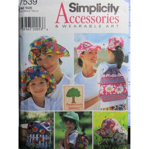 May include: Simplicity Accessories & Wearable Art pattern showing various hats and a drawstring backpack. The hats include a colourful butterfly design, a pink floral cap, and a green sun hat. The backpack has a daisy pattern.