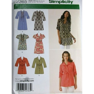 May include: Simplicity sewing pattern 2365 featuring various tunic and dress designs. The pattern includes illustrations of different styles, including long-sleeved and short-sleeved options, with details like belts and button-up fronts. The pattern also includes images of the finished garments.
