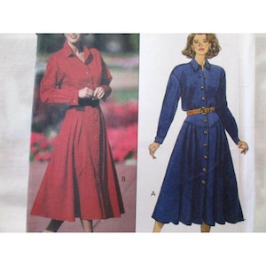 May include: Two long-sleeved dresses are shown. One is red, the other is blue denim. Both dresses have button-down fronts, collared necklines, and flared skirts. The blue dress has a brown belt. The dresses are shown on a white background.