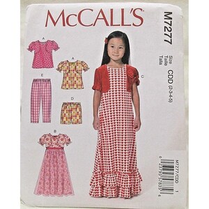 May include: A white ceramic mug with a black handle and the text "But First, Coffee" in a black, handwritten-style font. The mug is on a white surface.