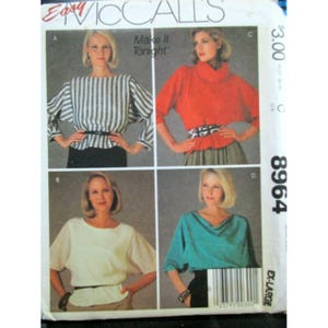 May include: A vintage McCall's sewing pattern with four blouse designs. The pattern includes a striped top, a red turtleneck, a white blouse, and a teal cowl neck top. The text "Easy McCall's" and "Make it Tonight" are visible.