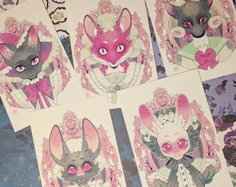 May include: A collection of art prints featuring stylized animal portraits. Each print showcases a different creature, such as a bat, fox, and rabbit, with ornate frames and pastel color palettes. The illustrations have a gothic and whimsical aesthetic.