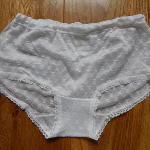 May include: White lace underwear with a delicate floral pattern.