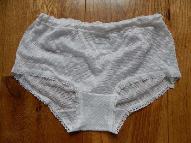 May include: White lace underwear with a delicate floral pattern.