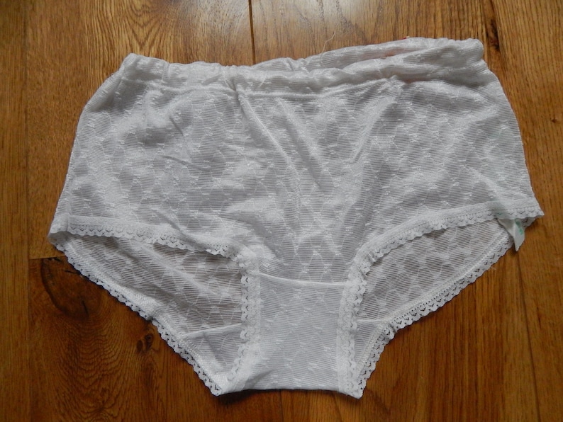 May include: White lace underwear with a delicate floral pattern and a white elastic waistband.