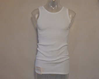 May include: White sleeveless undershirt with a crew neck.