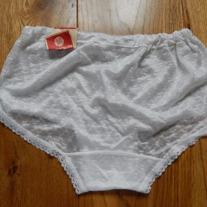 May include: White lace underwear with a white tag that says "SWS" on it.