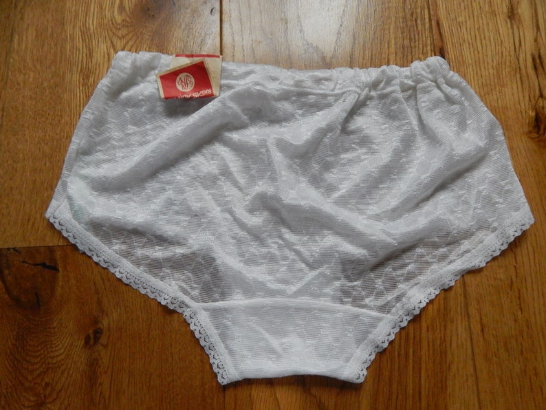May include: White lace underwear with a white tag that says "SWS" on it.