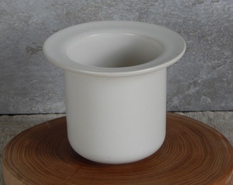 May include: A white ceramic planter with a wide rim, perfect for displaying small plants or succulents.
