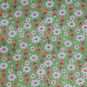 May include: Green fabric with a repeating pattern of white daisies and red tulips.
