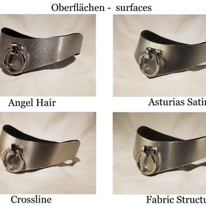 May include: Four silver metal collars with different finishes. The collars are all the same shape and have a ring on the front. The finishes are Angel Hair, Asturias Satin, Crossline, and Fabric Structure.