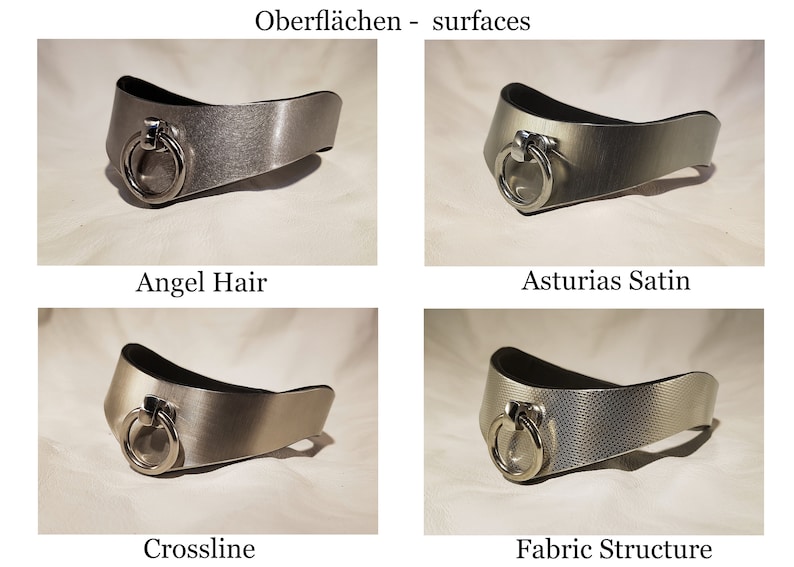 May include: Four silver metal collars with different finishes. The collars are all the same shape and have a ring on the front. The finishes are Angel Hair, Asturias Satin, Crossline, and Fabric Structure.