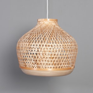 May include: A natural woven bamboo pendant light fixture with a round, dome-shaped shade.