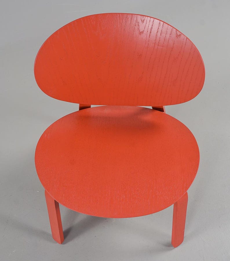 May include: A white ceramic mug with a black handle and the text "But First, Coffee" in a black, bold font. The mug is on a white surface.