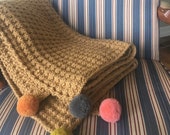 Large cozy blanket throw with decorative pom poms.Colorful with a houndstooth pattern. Approx 4 39 x5 39 . Machine washable