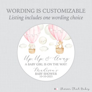 May include: Pink and white hot air balloon baby shower favor sticker with a bear and bunny in the balloons. The sticker says "Up. Up. & Away A Baby Girl Is On The Way! Madison's Baby Shower 10-10-2025"