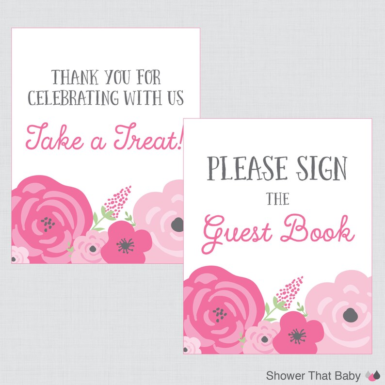 May include: Two white signs with floral designs and text. One sign reads "THANK YOU FOR CELEBRATING WITH US Take a Treat!" The other says "PLEASE SIGN THE Guest Book." Both have pink and white floral accents.