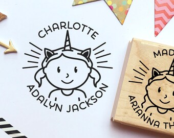 May include: Two wooden stamps with a unicorn design. The first stamp says "Charlotte Adalyn Jackson" and the second stamp says "Madison Arianna Thomas".