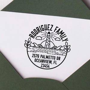 May include: Black and white custom return address stamp with a lighthouse, waves, and the text "Rodriguez Family" and "2576 Palmetto Dr Oceanview, FL 23454".