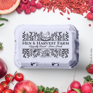 Custom rubber stamp impression reading "Hen & Harvest Farm – Naturally Raised · Farm Fresh" stamped in black ink on the inside lid of a green egg carton, shown with a dozen fresh brown eggs. Perfect for backyard chicken keepers, small farms, and handmade packaging.