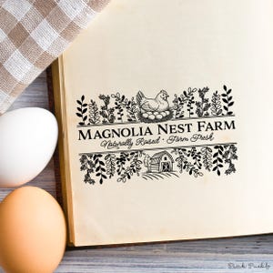 Custom rubber stamp impression reading "Hen & Harvest Farm – Naturally Raised · Farm Fresh" stamped in black ink on the inside lid of a green egg carton, shown with a dozen fresh brown eggs. Perfect for backyard chicken keepers, small farms, and handmade packaging.