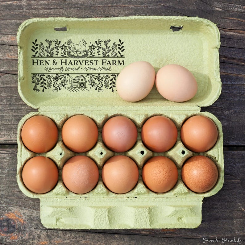 Custom rubber stamp impression reading "Hen & Harvest Farm – Naturally Raised · Farm Fresh" stamped in black ink on the inside lid of a green egg carton, shown with a dozen fresh brown eggs. Perfect for backyard chicken keepers, small farms, and handmade packaging.
