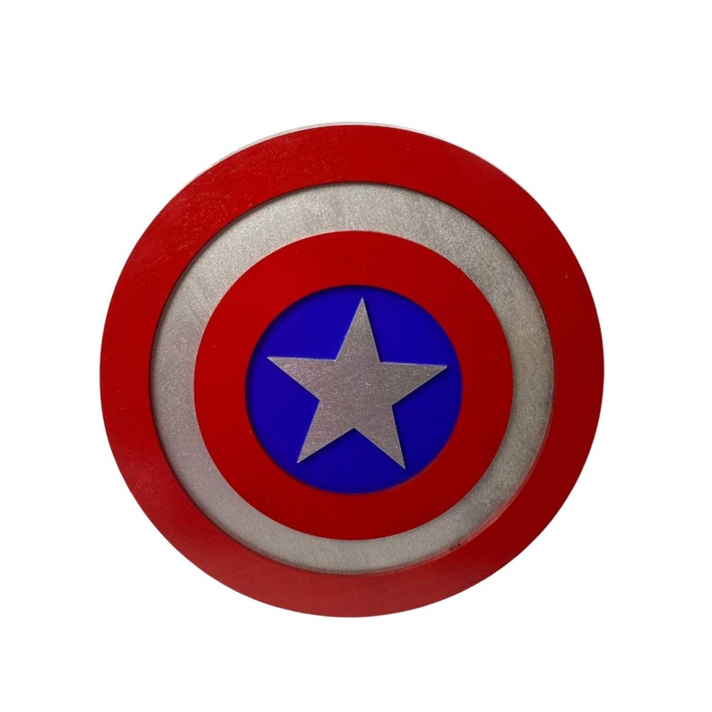 May include: A red, white, and blue circular shield with a silver five-pointed star in the center. The shield has a concentric circle design.