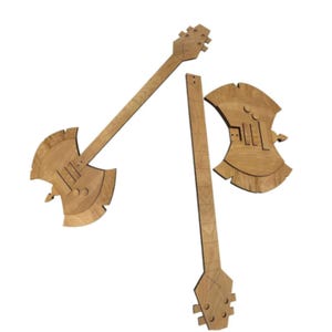 May include: Wooden guitar-shaped wall art pieces. The art pieces are light brown and feature a guitar headstock, neck, and axe-shaped body. The design includes cut-out details and a natural wood grain finish. The pieces are arranged against a white background.