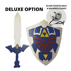 May include: Deluxe option for a blue and silver shield and sword set. The shield features the Triforce symbol and a red bird design. The sword has a blue and silver handle and a white blade. The back of the shield is silver and has straps for wearing.