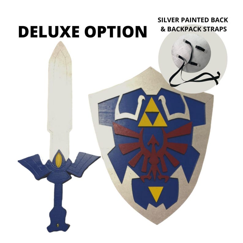 May include: Deluxe option for a blue and silver shield and sword set. The shield features the Triforce symbol and a red bird design. The sword has a blue and silver handle and a white blade. The back of the shield is silver and has straps for wearing.