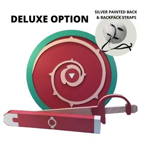 May include: A red and green shield with a spiral design and a matching sword in a sheath. The shield has a silver painted back and backpack straps. The text "DELUXE OPTION" is at the top.