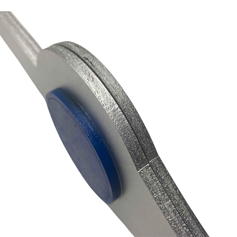 May include: Close-up of a silver-coloured metal tool with a blue rubber grip. The tool has a curved shape and a flat edge.