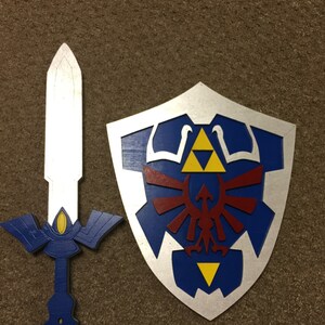May include: A blue and silver shield with a red and yellow Triforce symbol and a blue and silver sword with a gold handle.