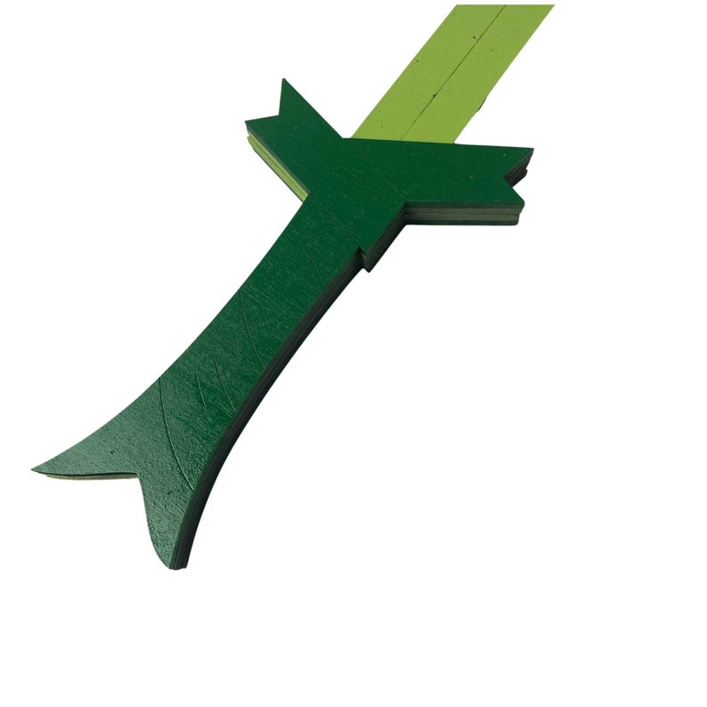 Puede incluir: Una espada de juguete de madera verde con una hoja amarilla. La espada est&aacute; hecha de m&uacute;ltiples capas de madera y tiene una superficie texturizada.