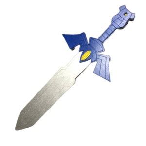 May include: A blue and silver plastic toy sword with a yellow detail. The sword is shaped like the Master Sword from the Legend of Zelda video game series.