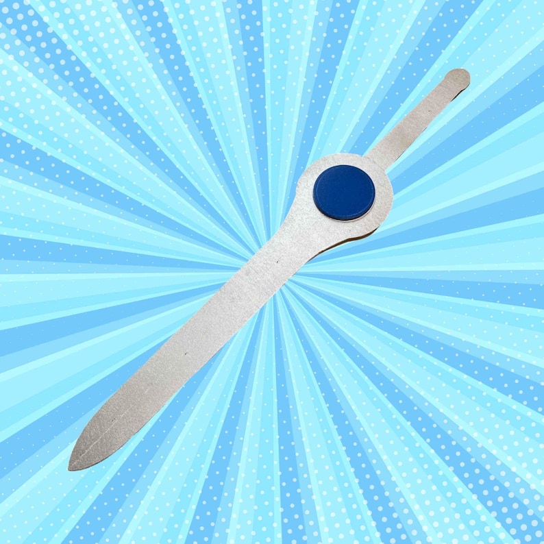 May include: A silver-coloured metal ruler with a blue circle at the centre. The ruler is on a blue and white background.