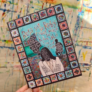 May include: A colorful illustration of Rosa Parks and Kamala Harris with the text "Rosa sat so Ruby could walk so Kamala could run". The illustration is framed with a black border and colorful squares.