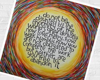 May include: A square art print featuring a bright yellow center surrounded by swirling, multi-colored brushstrokes in red, blue, and orange. The text reads: do not be daunted by the enormity of the world's grief. do justly, now. love, mercy, now.