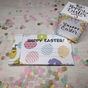 May include: A Happy Easter card with a colourful egg design and the text "Happy Easter!"  Instructions are on the back of the card.