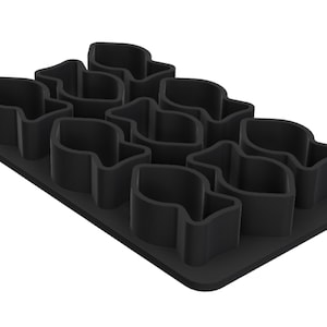 May include: A black silicone mould featuring ten individual cavities shaped like fish arranged in a grid pattern on a rectangular base. The mould has raised walls for each fish shape, designed for creating moulded items in a consistent fish silhouette.