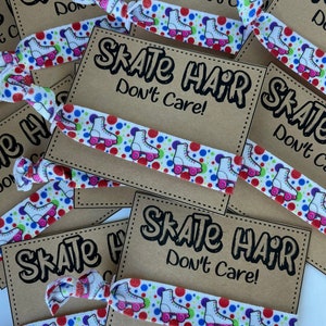 May include: A collection of hair ties with a white background. Each tie features a pattern of roller skates, red, blue, and green polka dots. The text "Skate Hair Don't Care!" is printed on a brown card.