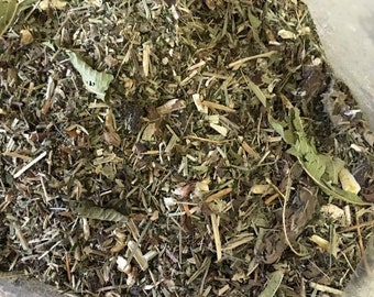 May include: A close-up of a bag of dried herbs and leaves, including green, brown, and white pieces.