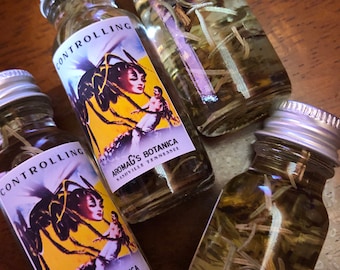 May include: Four small glass bottles with silver caps, filled with a clear liquid and herbs. The bottles have labels with the word "CONTROLLING" and a vintage-style illustration. The text "AROMAG'S BOTANICA NASHVILLE TENNESSEE" is also visible.