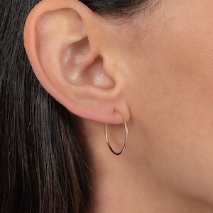 May include: A pair of gold hoop earrings. The earrings are simple and elegant, and they would make a great gift for any occasion.